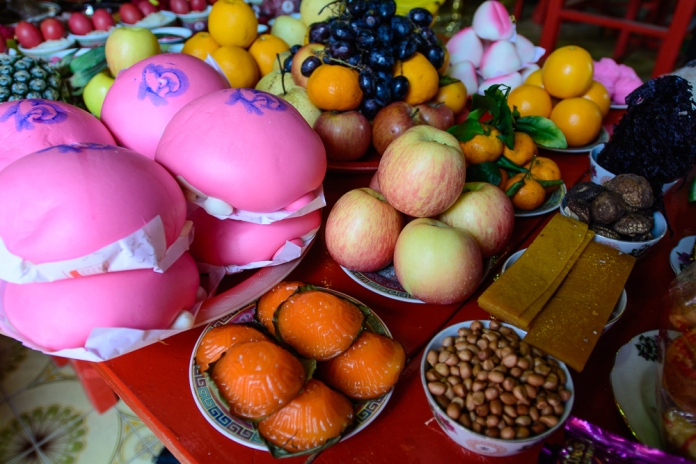 Food offerings at the altar of the Yap clan's patron deity, . Image: Altai World Photography.